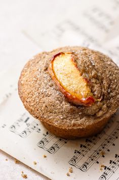 a muffin is sitting on top of sheet music