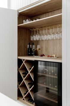 a wine rack with glasses and bottles in it