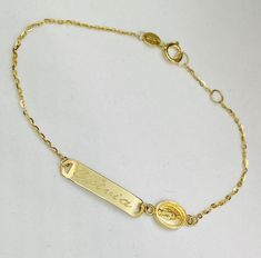 Baby ID with Miraculous Bracelet 14K yellow gold measuring 6'' inches long and ID plate measures 20mm. **Please note: When choosing what to engrave please make sure you write what you want engraved in boxes provided and choose font Block or Script if you have any questions please text or email us at: 786-589-3076 or bosjewelers@gmail.com** Personalized Yellow Gold Rectangular Name Bracelet, Personalized Rectangular Yellow Gold Name Bracelet, 14k Gold Name Bracelet With Engraving Option, Yellow Gold Nameplate Bracelet With Engraving Option, Engravable Nameplate Bracelet In Yellow Gold, Yellow Gold Nameplate Bracelet With Name Detail, Adjustable Gold Name Bracelet With Hallmarks, 14k Gold Engraved Nameplate Bracelet, Personalized Nameplate Gold Bracelet In Yellow Gold