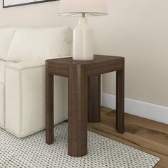 a white couch sitting next to a wooden table on top of a hard wood floor