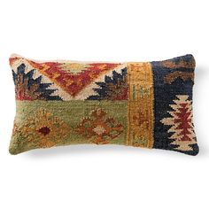 a decorative pillow with multicolored squares on the front and back, sitting on a white background