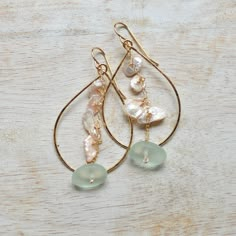 Add a touch of whimsy to your look with these unique Keshi Pearl & Frosted Glass Teardrop earrings. Handmade in Hawaii, these dainty earrings feature delicate freshwater pearls in a soft pink hue, dangling from a gold filled chain with a hint of sea foam frosted glass. A playful addition to any outfit! Made in Honolulu, Hawaii Soft pink freshwater Keshi pearls Sea foam frosted glass Hammered teardrop measures approximately 1.5" long and weighs 19g. Delicate Handmade Drop Earrings, Feminine Teardrop Pearl Charm Earrings, Delicate Pink Pearl Earrings, Elegant Wire Wrapped Drop Hoop Earrings, Dainty Teardrop Pearl Earrings Wire Wrapped, Dainty Teardrop Wire Wrapped Pearl Earrings, Delicate Teardrop Pearl Drop Dangle Earrings, Delicate Teardrop Earrings With Ear Wire, Delicate Pearl Drop Hoop Earrings