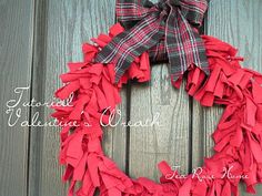 a red and black wreath is hanging on a wooden door with the words, national valentine's wreath