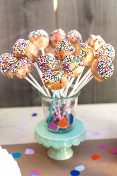 sprinkled donuts in a glass vase on a table