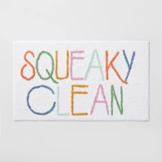 the word sqeaky clean is painted on a white towel with multicolored letters