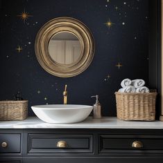 a bathroom with a sink, mirror and baskets on the counter top in front of it