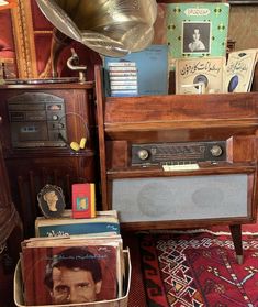 an old radio sitting on top of a table next to some books and other items