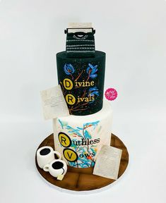 there is a cake that has been made to look like a bottle and two mugs