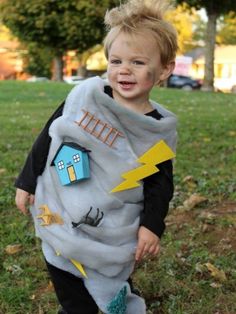 a young boy dressed up in a costume