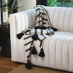 a black and white striped blanket sitting on top of a couch