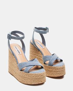 Elevate your style with LULAH   sandals . Featuring a raffia sole and a comfortable   wedge , these sandals are perfect for any summer adventure. The crisscross front strap and ankle strap add a touch of elegance, while the platform provides extra support.  5 inch heel height 2 inch platform Textile upper material Synthetic lining Synthetic sock Synthetic sole Imported Denim Espadrilles, Steve Madden Store, Comfortable Wedges, Summer Heels, The Platform, 5 Inch Heels, Denim Fabric, Fun Bags, Women's Sandals