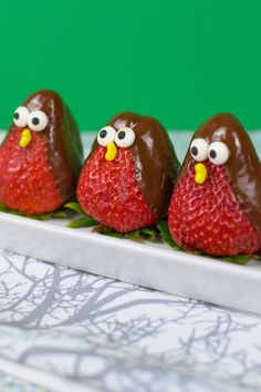 three chocolate covered strawberries in the shape of birds