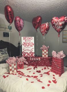 valentine's day decorations and gifts on a bed