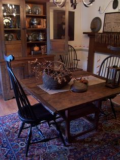 an old fashioned dining room table with chairs