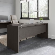 an office desk with a laptop on it