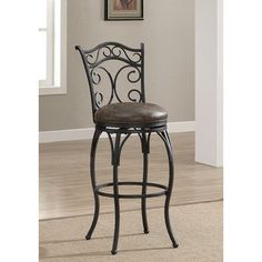 a black metal bar stool with brown leather upholstered seat and backrests