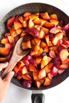 someone is holding a wooden spoon in a bowl full of chopped vegetables with the words, combine plums and water