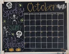 a chalkboard with a calendar on it that says october and is decorated with halloween decorations