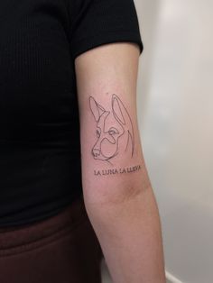 a woman with a dog tattoo on her arm