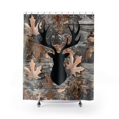 a shower curtain with an image of a deer's head and leaves on it