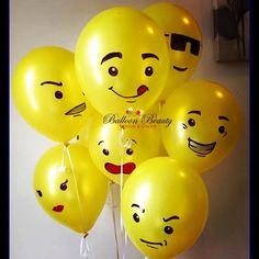 a bunch of yellow balloons with faces on them