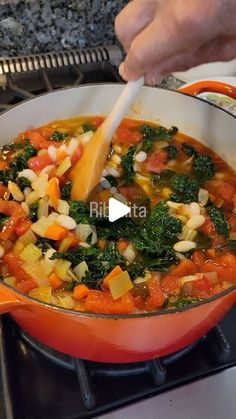 a pot filled with vegetables cooking on top of a stove