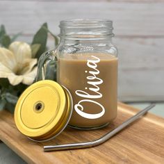 there is a glass jar with some liquid in it and a spoon next to it