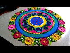 a colorful rug is sitting on the floor with flowers and circles in it's center