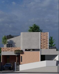 a car is parked in front of a modern house with brick and concrete exteriors