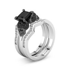 two wedding rings with black diamonds on them