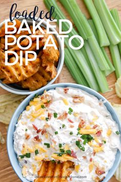 loaded baked potato dip in a blue bowl with green beans and celery on the side