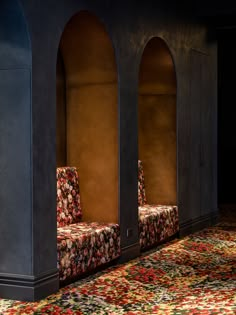 an ornately decorated room with two chairs and a rug on the floor in front of it