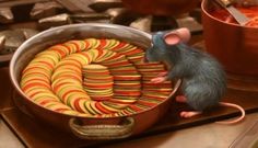 a mouse sitting on top of a metal pan filled with candy canes next to a pot