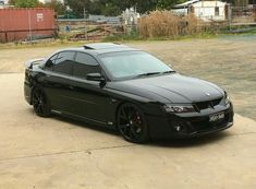 a black sports car parked in a parking lot