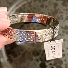 Nwt Coach Silver Plated Bangle Bracelet With Signature C's. 2 Coach Stamps Inside. No Flaws Or Scratches. Tag Attached. Smoke And Pet Free Home. 1/2" Wide. Coach Metal Bangle Jewelry, Coach Silver Bangle Bracelets, Coach Silver Bangle Bracelet, Elegant Coach Bangle Jewelry, Coach Adjustable Bangle, Adjustable Coach Bangle, Coach Metal Bracelet Jewelry, Formal Adjustable Coach Bracelets, Silver Coach Bracelet Gift