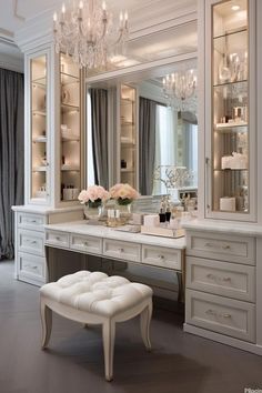 a white dressing room with chandelier and stool