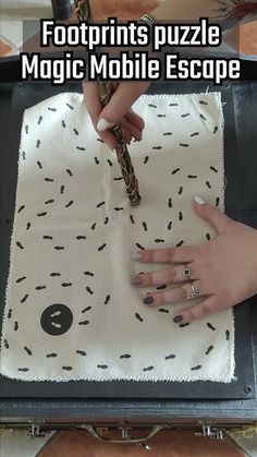 a woman is using a snake to get her nails polish done on the table with text overlay that reads, footprints puzzle magic mobile escape