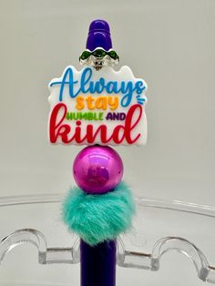 there is a sign that says always stay and be kind on top of a ball