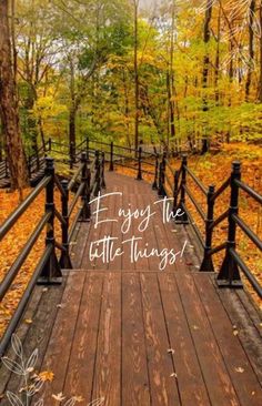 a wooden bridge with the words enjoy the little things written on it in white lettering