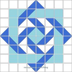 a blue and white quilt block with squares in the shape of an inverted triangle on it