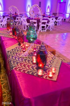 the tables are set up with candles and vases