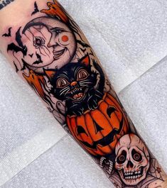 an arm with halloween tattoos on it