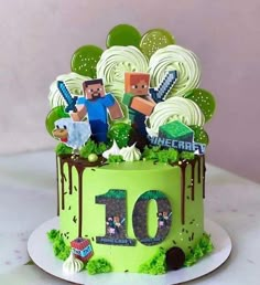 a birthday cake with the number 10 on it and minecraft characters in green frosting