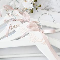 wedding hangers with names and ribbons on them