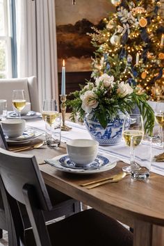 a dining room table set for christmas dinner