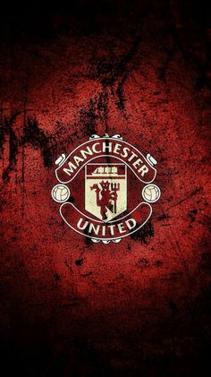 the manchester united logo is painted on a red wall with black grungy paint