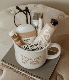 a cup filled with personal care items sitting on top of a table next to a notebook