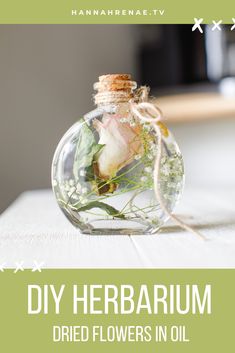 a glass bottle filled with flowers on top of a wooden table next to an air plant