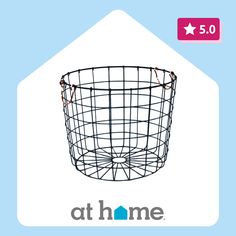 a black wire basket sitting on top of a blue background with the words at home above it