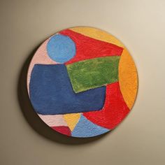 a circular painting on the wall with different colors